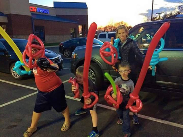 a family posing with balloon swords at mexicali grill