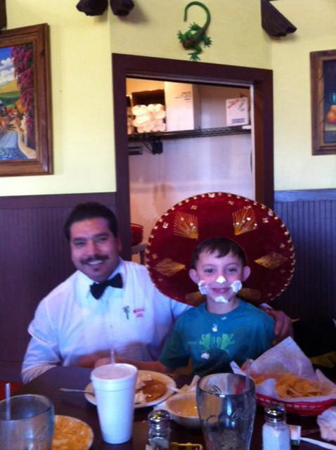 child with whipped cream on his face celebrating his birthday at Mexicali Grill