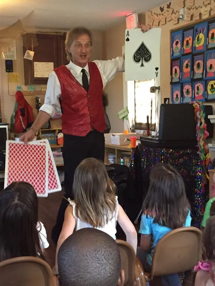 Rodney the Magician doing a card trick with very large playing cards