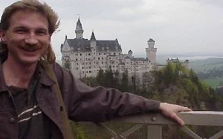 Magician Rodney Kelley posing with Neuschwanstein Castle in background