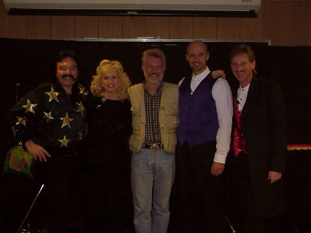 Magician Rick Moore, Donna Moore, Road Rage Rudy, Ventriloquist David Turner, Magician Rodney Kelley posing on stage before a magic show in Germany