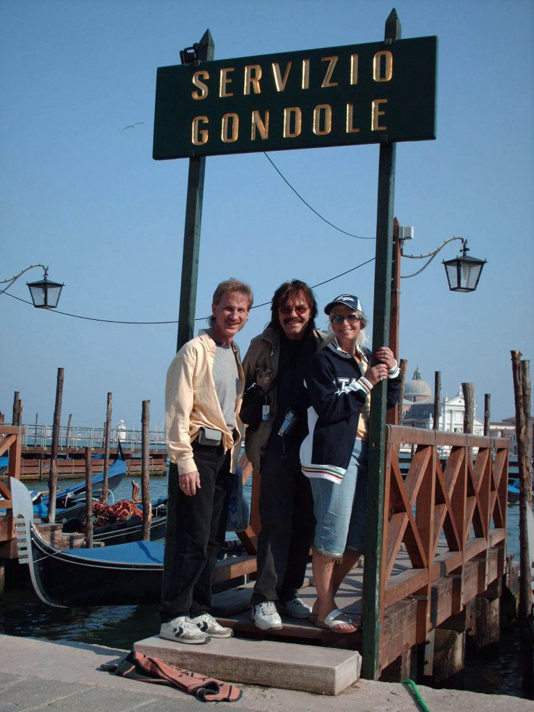 Rodney Kelley, Rick Moore, Donna Moore standing and waiting for a gondola ride in Venice