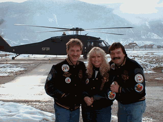 Magician Rodney Kelley with Donna Moore, Rick Moore in front of a blackhawk helicopter in Bosnia Herzegovina