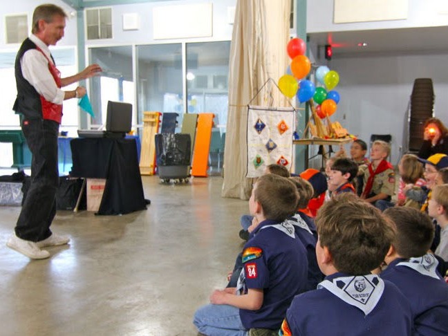 Magician Rodney Kelley performing silk trick for Boy Scout group