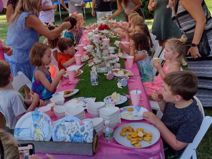 kids at a birthday party sitting at table having cake