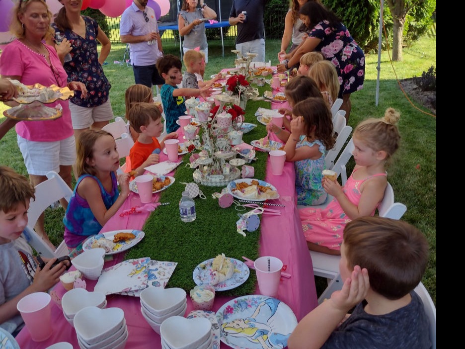 kids at a birthday party sitting at table having cake