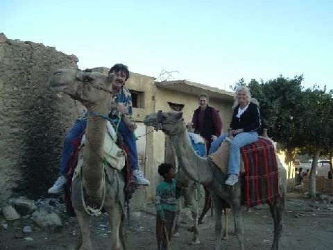 Rick Moore, Donna Moore, Rodney Kelley on camels ready to go to the Pyramids of Egypt
