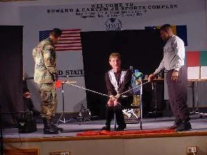 Magician Rodney Kelley doing a rope escape in Bosnia for military audience