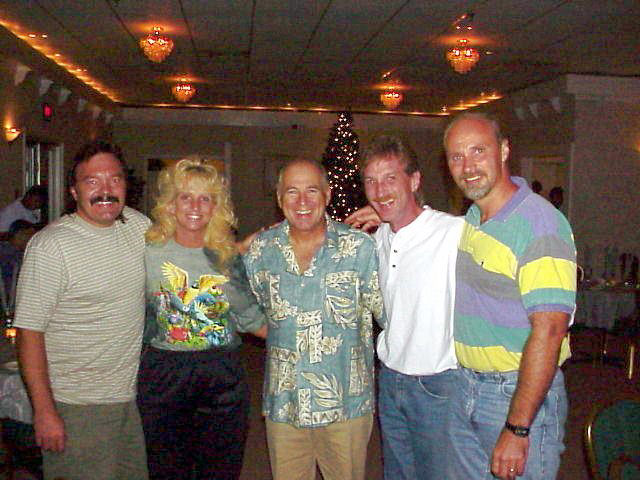 Magician Rodney Kelley with Rick Moore, Donna Moore, Dave Turner posing with Jimmy Buffett at Guatanamo Bay Cuba
