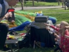 children watching Rodney the Magician performing balloon trick