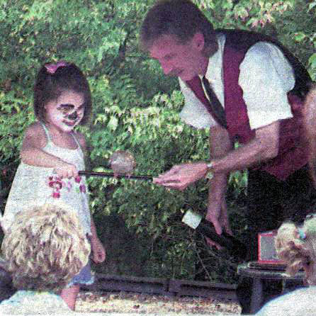 girl volunteer holding wand with bird on it