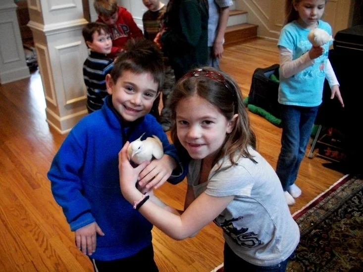 two children petting the magical doves after the magic show